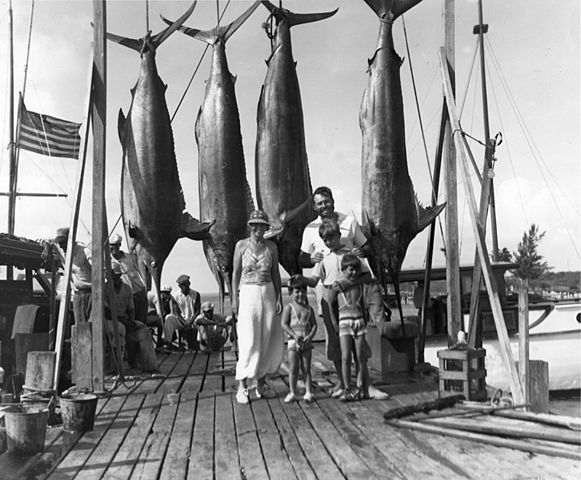 American author Ernest Hemingway with Pauline, Gregory, John, and Patrick Hemingway and four marlins on the dock in Bimini, 20 July 1935.