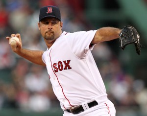 Boston Red Sox starting pitcher Tim Wakefield delivers a knuckleball against the Texas Rangers during the first inning of a MLB baseball game at Fenway Park in Boston Tuesday, April 20, 2010. (AP Photo/Winslow Townson)